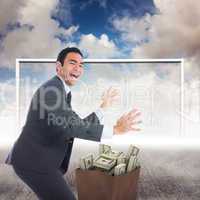 Composite image of excited businessman catching