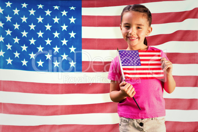 Composite image of little girl with american flag