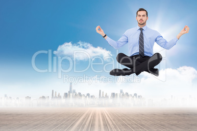 Composite image of calm businessman sitting in lotus pose