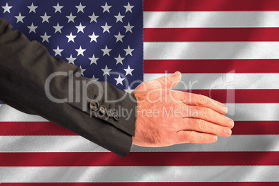 Composite image of businessman reaching hand out