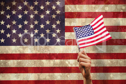 Composite image of hand waving american flag