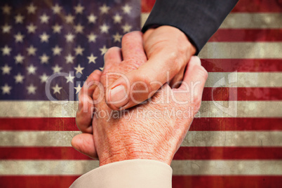 Composite image of close up on business people shaking hands