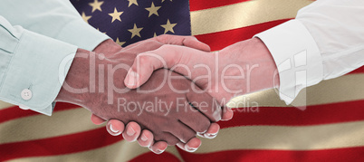 Composite image of close-up shot of a handshake in office