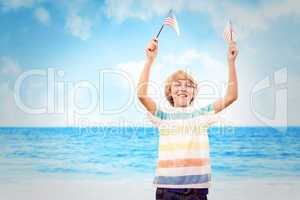 Composite image of cute boy with american flag