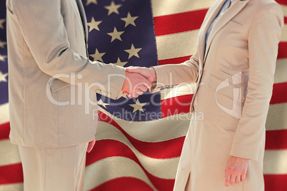 Composite image of business people shaking hands