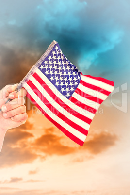 Composite image of hand waving american flag