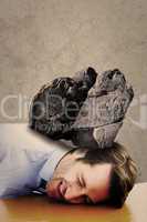 Composite image of casual businessman sleeping at his desk