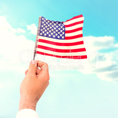 Composite image of hand waving american flag