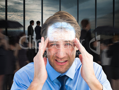 Composite image of young businessman with severe headache