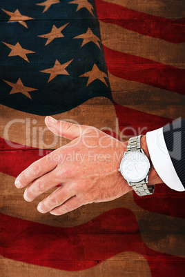 Composite image of businessman in suit clenching fists