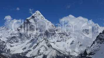 Peak of Ama Dablam surrounded by clouds