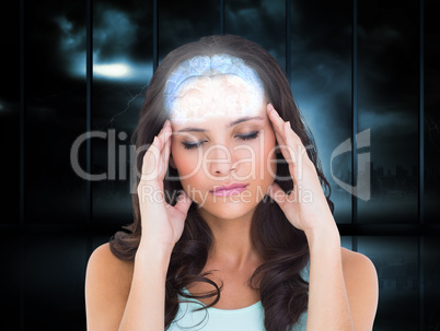 Composite image of pretty brunette with a headache