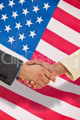 Composite image of closeup of shaking hands over eye glasses and