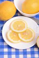 Fresh juicy sliced lemon on a ceramic plate.