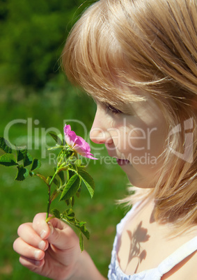 child smelling blossom