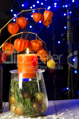 Christmas background with physalis in candlelight