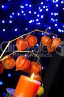 Christmas background with physalis in candlelight