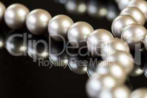 Elegant Pearl Necklace on Glossy Table