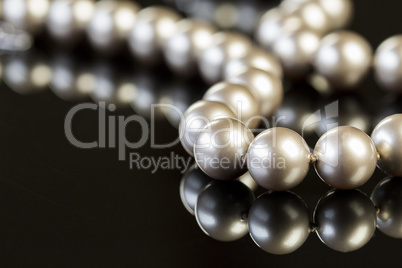 Elegant Pearl Necklace on Glossy Table