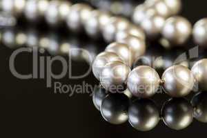 Elegant Pearl Necklace on Glossy Table