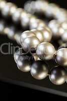 Elegant Pearl Necklace on Glossy Table