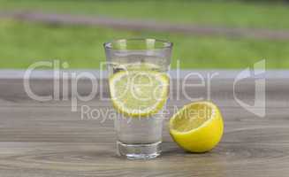 Glass of fresh cold mineral water with lemon
