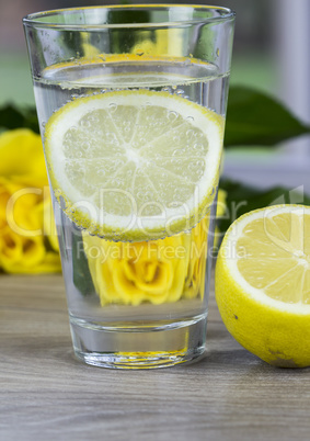 Glass of fresh cold mineral water with lemon