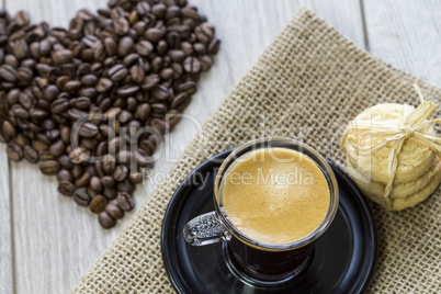 Strong mug of espresso coffee with coffee beans