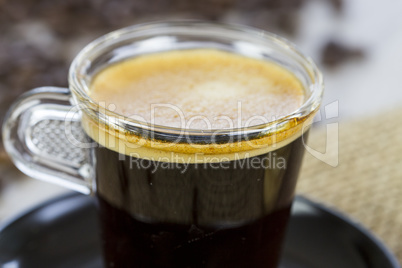 Strong mug of espresso coffee with coffee beans