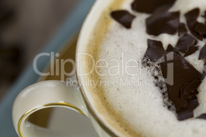 Cup of fresh cappuccino with chocolate flakes