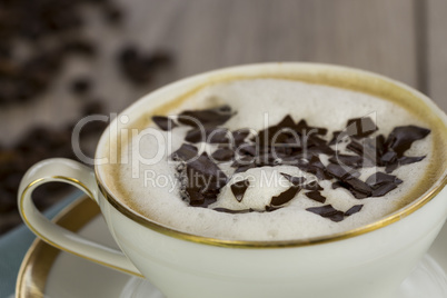 Cup of fresh cappuccino with chocolate flakes