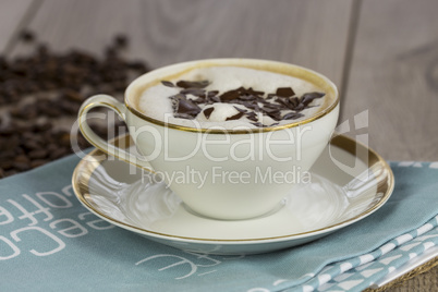 Cup of fresh cappuccino with chocolate flakes