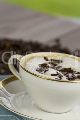 Cup of fresh cappuccino with chocolate flakes