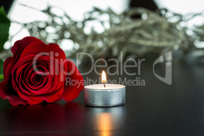 Red Rose and Small Candle on Table