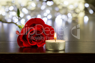 Red Rose and Small Candle on Table
