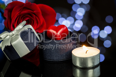 Rose, Candle and Jewelry Present Gift Box on Table