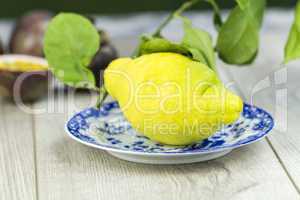 Fresh yellow lime or lemon on a plate