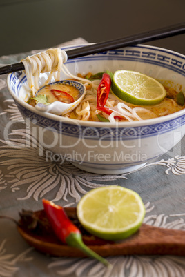 Bowl of spicy Asian soup with noodles