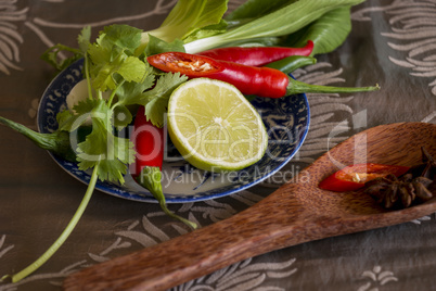 Spices, fresh herbs and lemon in a kitchen