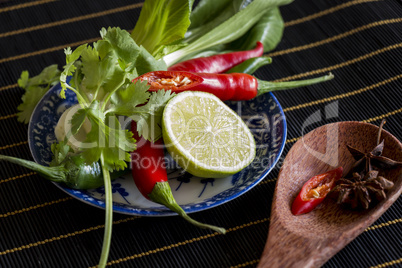 Spices, fresh herbs and lemon in a kitchen