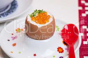 Boiled egg with caviar for breakfast