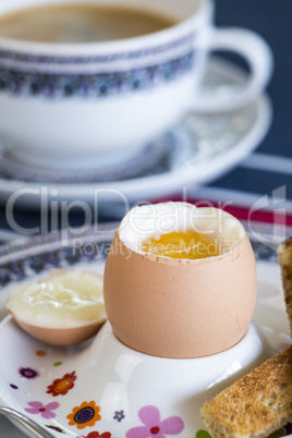 Breakfast of boiled egg, coffee and pastries