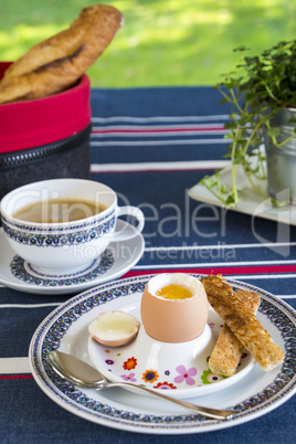 Breakfast of boiled egg, coffee and pastries
