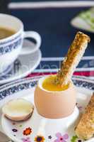 Breakfast of boiled egg, coffee and pastries
