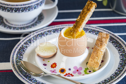 Breakfast of boiled egg, coffee and pastries