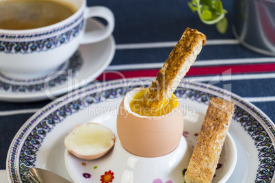 Breakfast of boiled egg, coffee and pastries