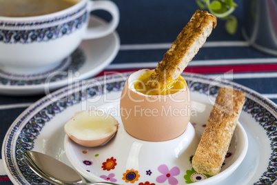 Breakfast of boiled egg, coffee and pastries