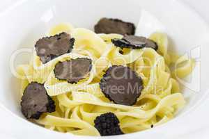 Serving of pasta with black Perigord truffles