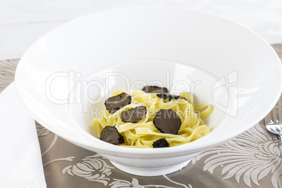 Serving of pasta with black Perigord truffles