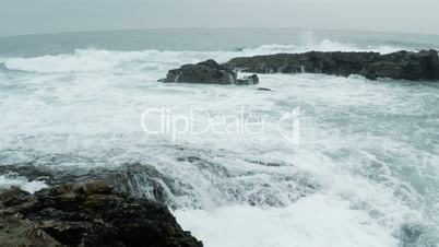 Cold Ocean Surf on the Rocky Shore. Slow Motion